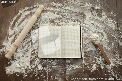 Image of Recipe book on floured table.