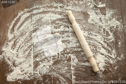 Image of Scattered flour on wooden table.