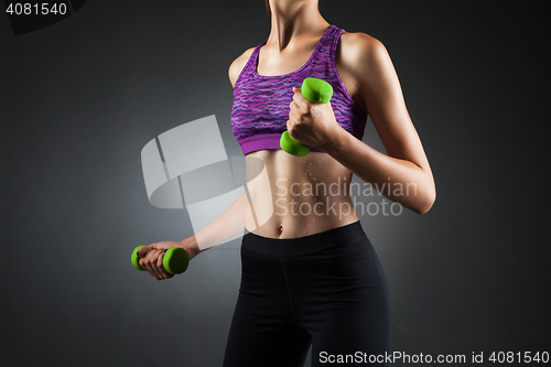 Image of Beautiful anonymous woman doing biceps exercises.