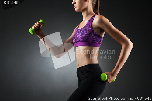 Image of Beautiful woman doing biceps exercises.