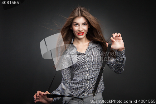 Image of Happy woman pulling suspenders.