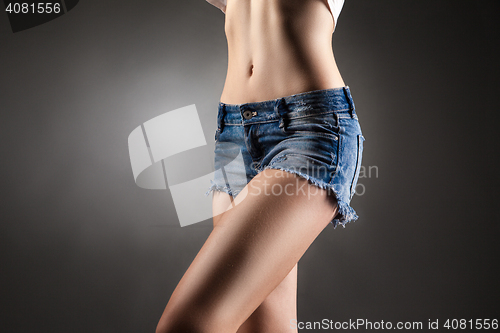 Image of Waist of slim girl posing faceless.