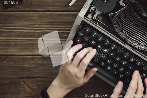 Image of Writer typing with retro writing machine.