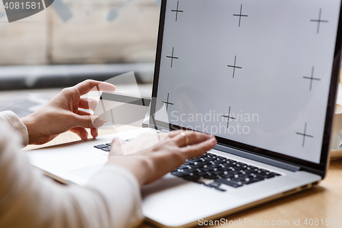 Image of Woman holding credit card and typing