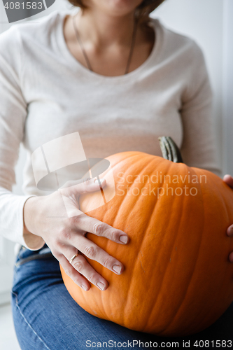 Image of Woman holding pumpkin