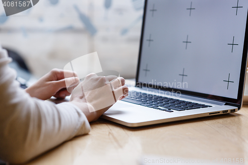 Image of Woman works on laptop