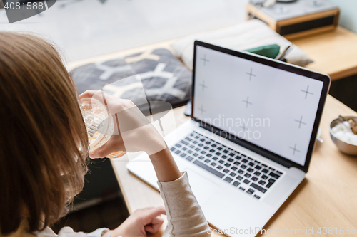 Image of Woman drinks a water when working