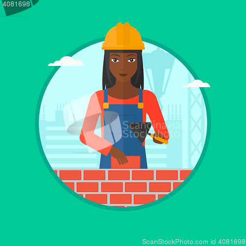 Image of Bricklayer with spatula and brick.