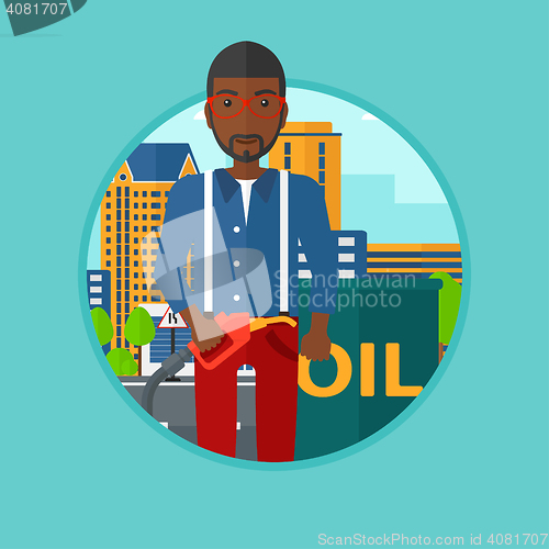 Image of Man with oil barrel and gas pump nozzle.