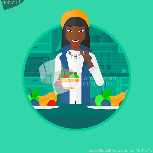 Image of Woman eating healthy vegetable salad.