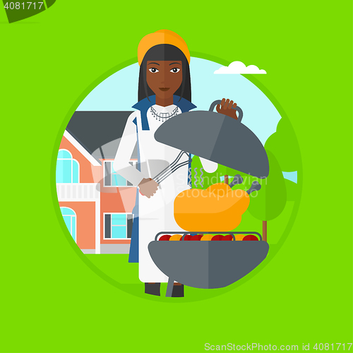 Image of Woman cooking chicken on barbecue grill.