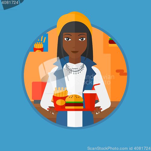 Image of Woman with tray full of fast food.