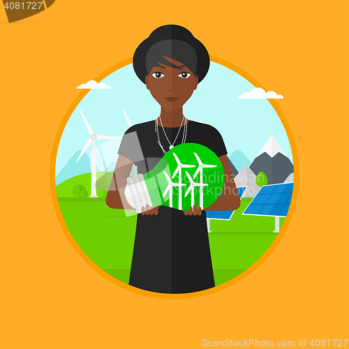 Image of Woman holding lightbulb with wind turbines inside.