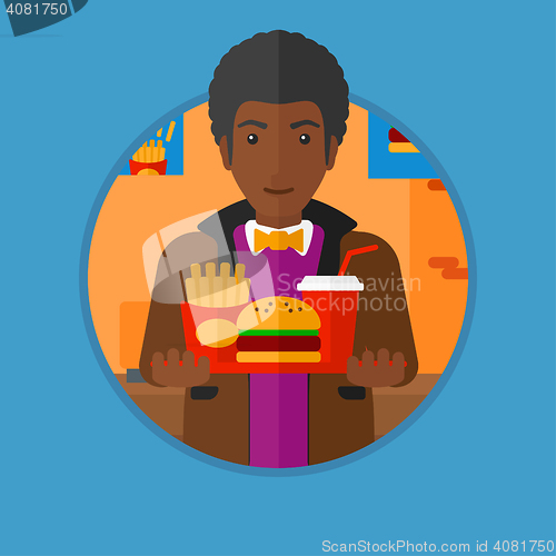 Image of Man with tray full of fast food.