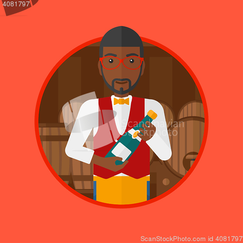 Image of Waiter holding bottle in wine cellar.