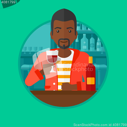 Image of Man drinking wine at restaurant.