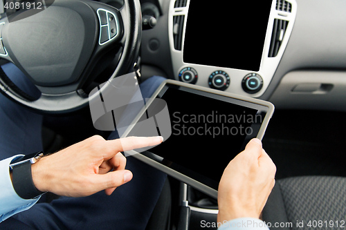 Image of close up of man with tablet pc in car