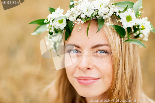 Image of happy woman in wreath of flowers