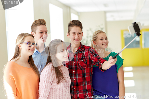 Image of students taking selfie with smartphone at school