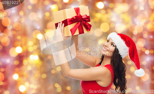 Image of beautiful sexy woman in santa hat with gift box