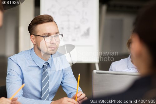 Image of smiling business people meeting in office