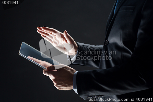Image of close up of businessman with transparent tablet pc