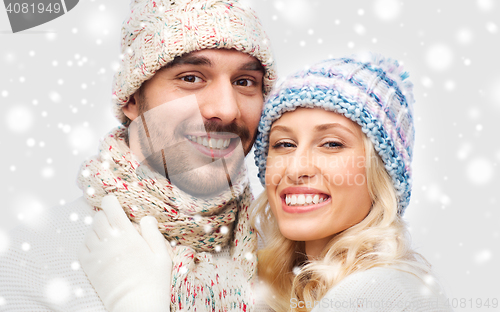 Image of smiling couple in winter clothes hugging