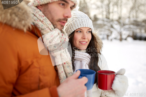 Image of close up of happy couple with tea cups in winter