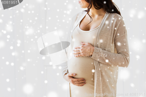 Image of close up of pregnant woman looking to window