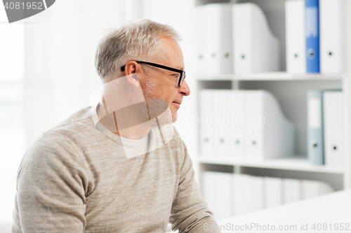 Image of senior man sitting  at medical office