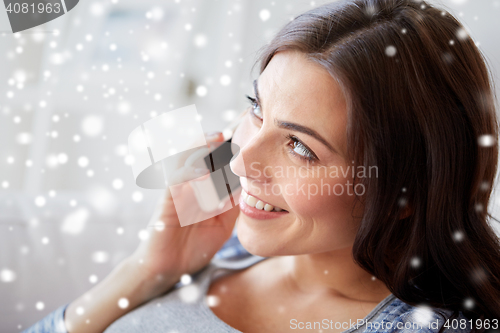 Image of close up of woman calling on smartphone at home