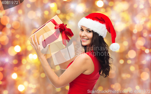 Image of beautiful sexy woman in santa hat with gift box