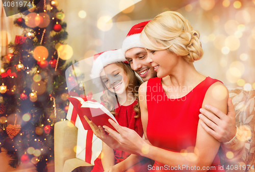 Image of smiling family reading book