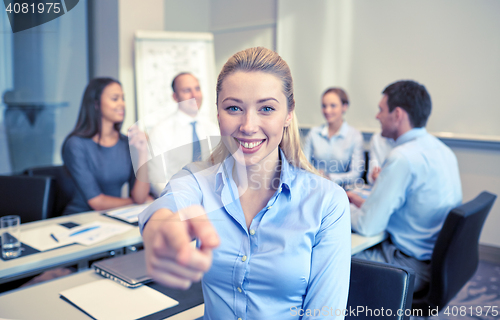 Image of group of smiling businesspeople meeting in office