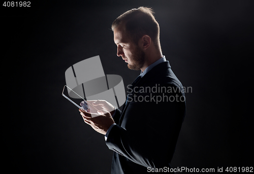 Image of close up of businessman with transparent tablet pc