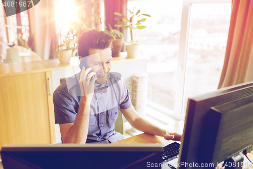 Image of happy creative male worker calling on smarphone