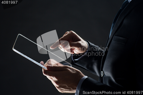Image of close up of businessman with transparent tablet pc