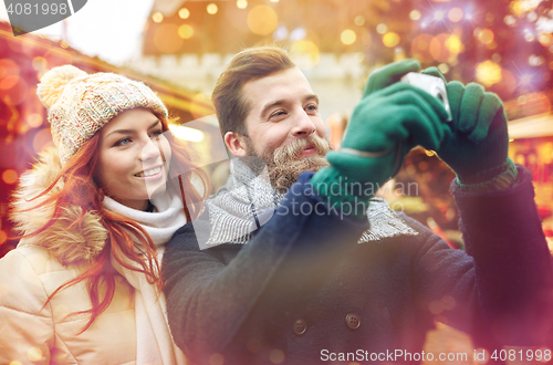 Image of couple taking selfie with smartphone in old town