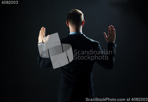 Image of businessman touching virtual screen