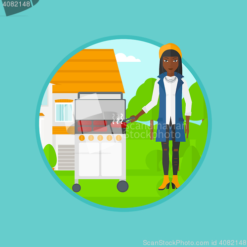 Image of Woman cooking meat on gas barbecue grill.