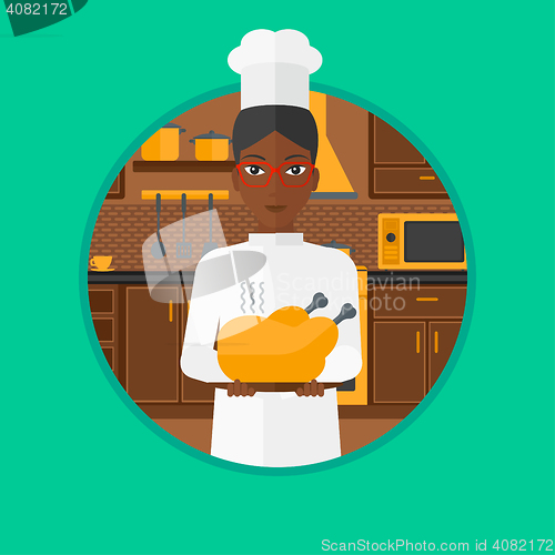 Image of Chief cooker holding roasted chicken.