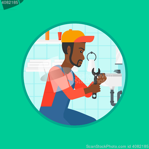 Image of Plumber fixing sink pipe with wrench.