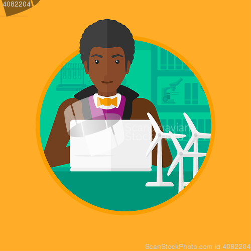 Image of Man working with model wind turbines on the table.