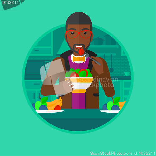 Image of Man eating healthy vegetable salad.