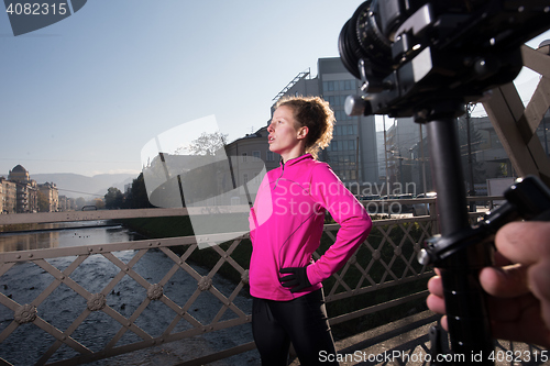 Image of woman  stretching before morning jogging