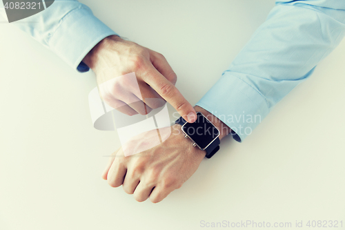 Image of close up of male hands setting smart watch