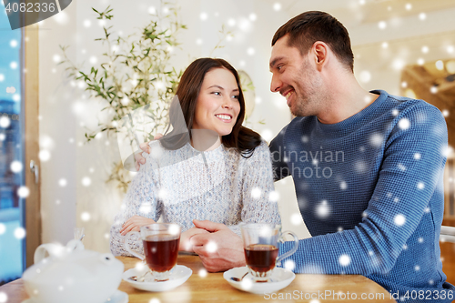 Image of happy couple drinking tea at restaurant