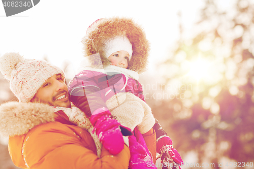 Image of happy family in winter clothes outdoors