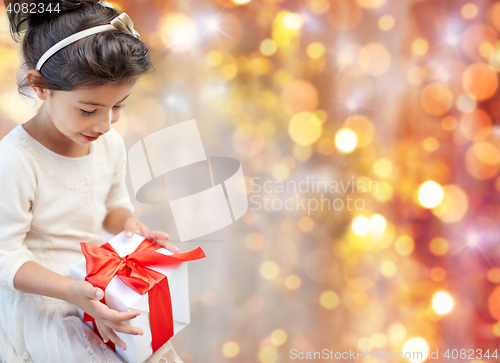 Image of smiling little girl with gift box