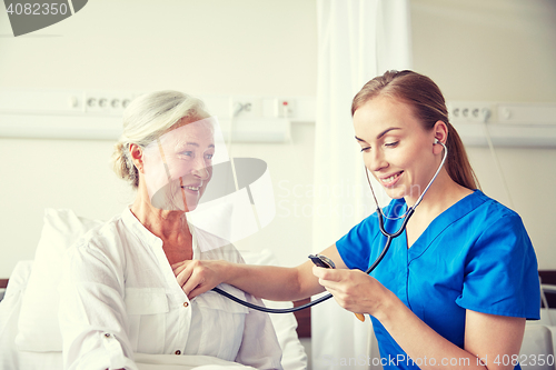 Image of nurse with stethoscope and senior woman at clinic